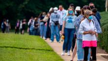 FAIRFAX, VIRGINIA - SEPTEMBER 18: People stand on line,  spaced six apart due to COVID-19, in order to vote early at the Fairfax Government Center on September 18, 2020 in Fairfax, Virginia. Voters waited up to four hours to early vote in the upcoming 2020 presidential election, polls opened at 8am, and people where in line at 5:45am according to poll workers. (Photo by Tasos Katopodis/Getty Images)