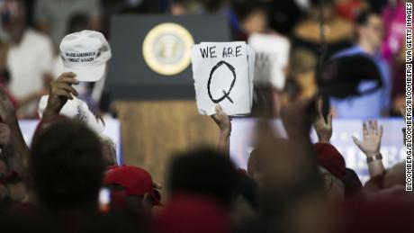 An attendee at a Trump rally holds up a QAnon sign on August 4, 2018. (Bloomberg via Getty Images)
