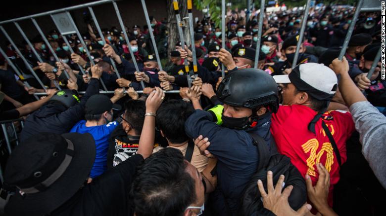 Pro-democracy protesters seen pushing back Thai police during an anti-government demonstration on October 14, 2020 in Bangkok, Thailand. 