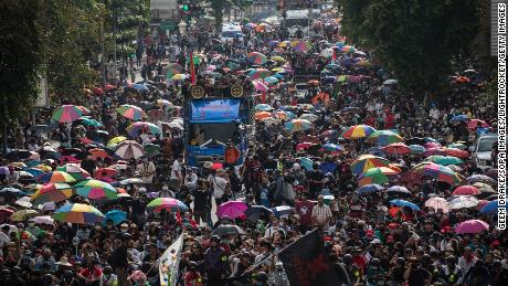 Protesters seen walking toward Government House during an anti-government demonstration in Bangkok.