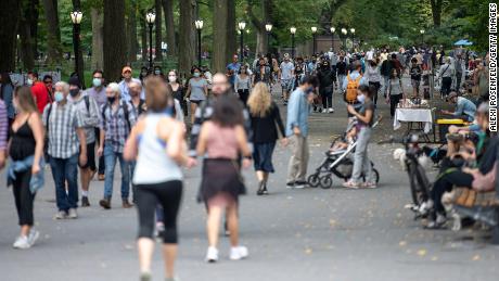 NEW YORK, NEW YORK - SEPTEMBER 26: People with and without masks avoid social distancing while walking in Central Park as the city continues Phase 4 of re-opening following restrictions imposed to slow the spread of coronavirus on September 26, 2020 in New York City. The fourth phase allows outdoor arts and entertainment, sporting events without fans and media production. (Photo by Alexi Rosenfeld/Getty Images)