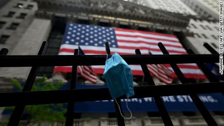 A face mask is seen in front of the New York Stock Exchange (NYSE) on May 26, 2020 at Wall Street in New York City. - Global stock markets climbed Monday, buoyed by the prospect of further easing of coronavirus lockdowns despite sharp increases in case rates in some countries such as Brazil. Over the weekend, US President Donald Trump imposed travel limits on Brazil, now the second worst affected country after the United States, reminding markets that while the coronavirus outlook is better, the crisis is far from over. (Photo by Johannes EISELE / AFP) (Photo by JOHANNES EISELE/AFP via Getty Images)