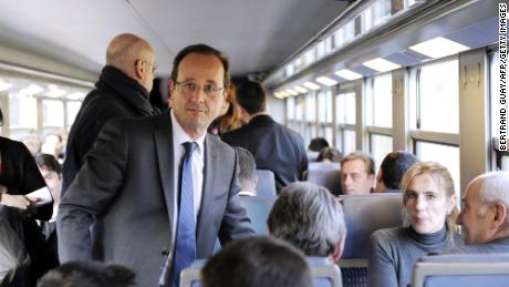 French President Francois Hollande stands in a commuter train during a 2012 campaign trip.