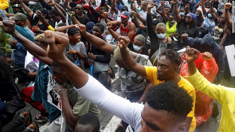 Demonstrators gesture during a protest in Lagos, Nigeria, on Wednesday, October 14.