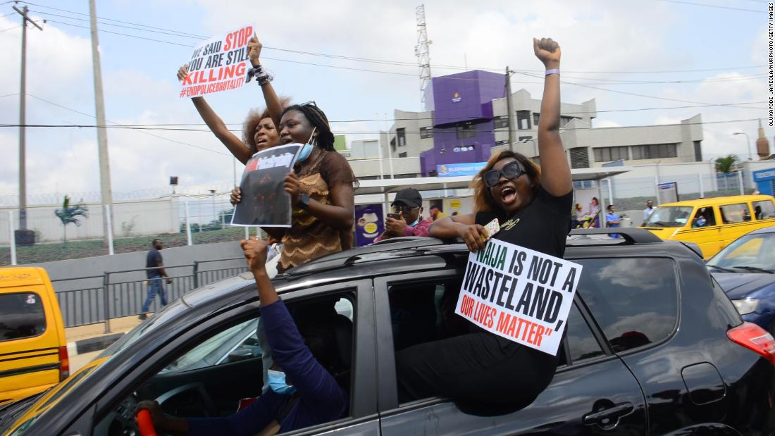 People protest from a car in Ikeja on October 13.