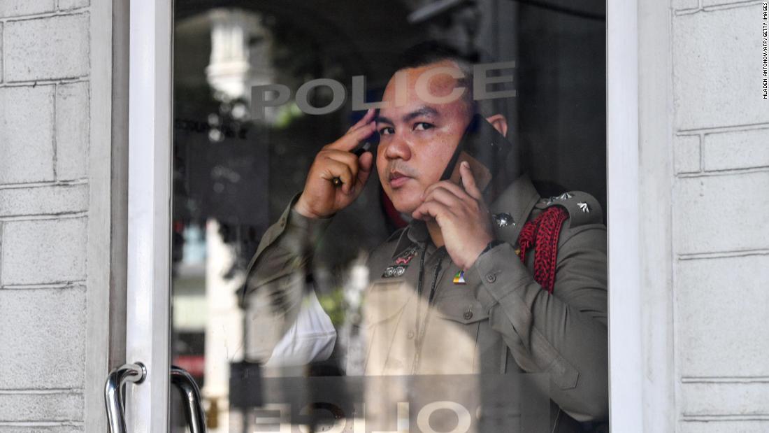 A policeman looks on from his booth in Bangkok on October 15.