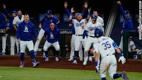 Cody Bellinger of the LA Dodgers celebrates with his teammates after hitting a home run in the seventh inning during Game 7 of the NLCS against the Atlanta Braves.