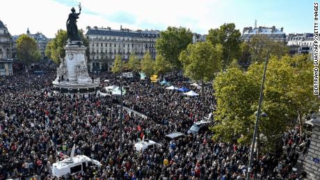 People gather on Place de la Republique in Paris, France on October 18, to pay homage to history teacher Samuel Paty two days after he was beheaded.