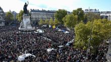 People gather on Place de la Republique in Paris, France on October 18, to pay homage to history teacher Samuel Paty two days after he was beheaded.