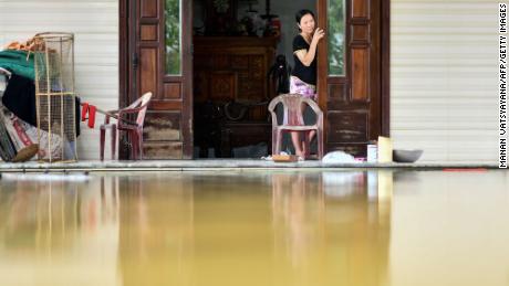A woman looks out from her flooded house in Quang Dien district in central Vietnam&#39;s Hue province on October 15, 2020. 