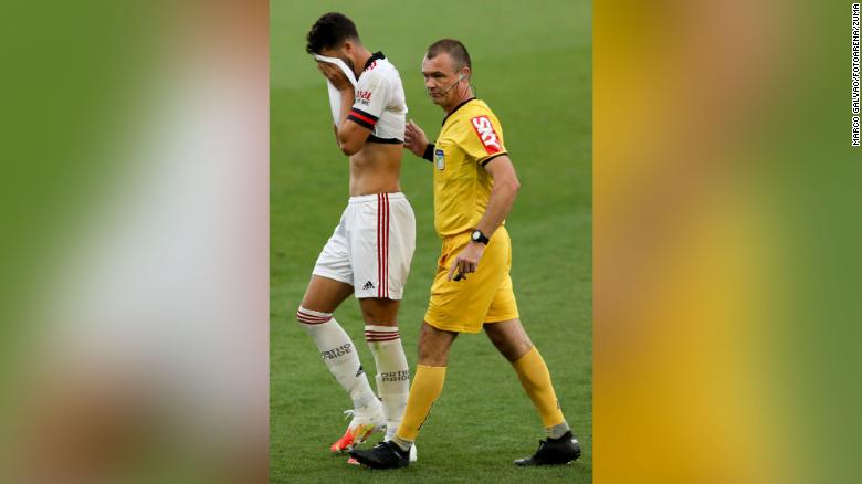 Henrique is helped from the field following his injury. 