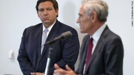 Florida Gov. Ron DeSantis, left, looks on as Dr. Scott Atlas, President Donald Trump&#39;s new pandemic advisor, gestures as during a news conference at the University of South Florida Morsani College of Medicine and Heart Institute Monday, Aug. 31, 2020, in Tampa, Fla. (AP Photo/Chris O&#39;Meara)