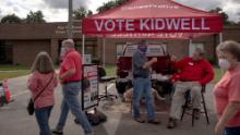 Rep. Keith Kidwell greets voters near an early voting site in Washington, North Carolina.
