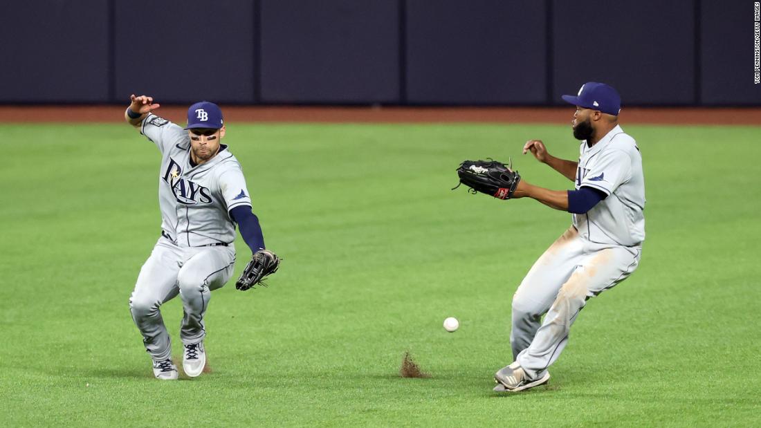 Rays outfielders Kevin Kiermaier, left, and Manuel Margot fail to catch a fly ball hit by Dodgers third baseman Justin Turner.