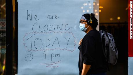 A handwritten sign on a window of a shop announces its closure in Swansea city centre, south Wales, a day before the &quot;fire-break&quot; lockdown comes into force.