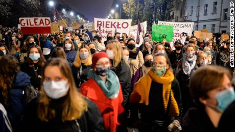  Activists hold placards as they protest in Warsaw against the abortion ban.
