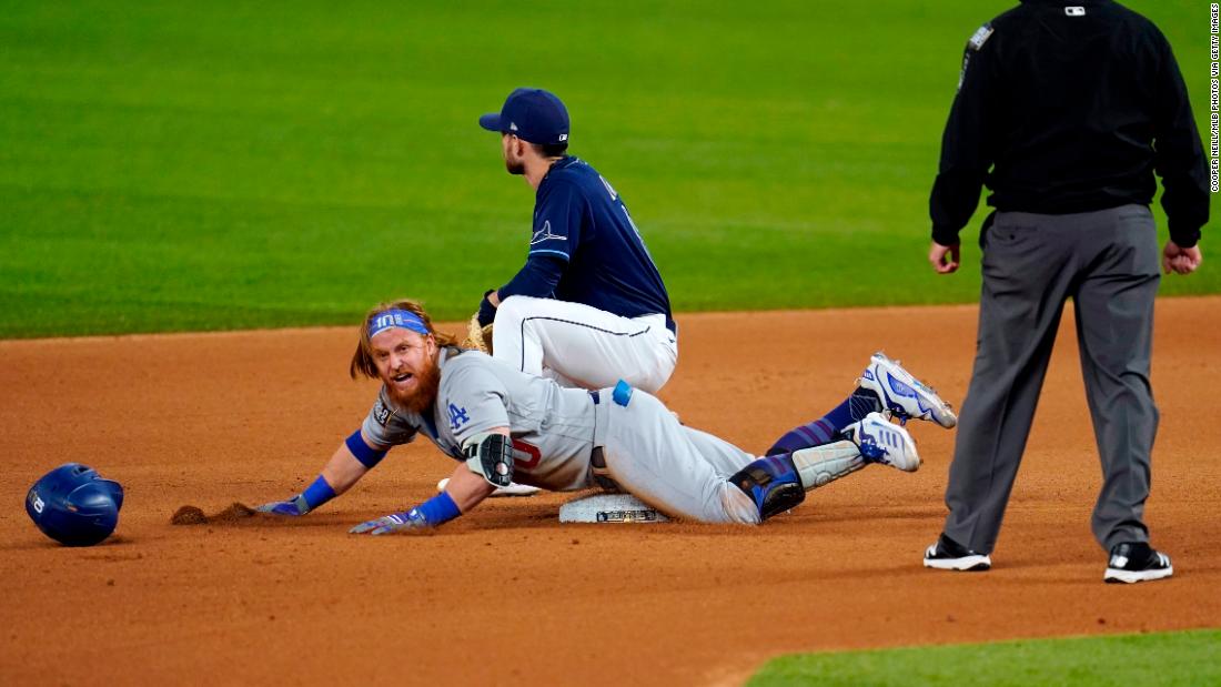 The Dodgers&#39; Justin Turner slides into second base with a double in the seventh inning during Game 4. 