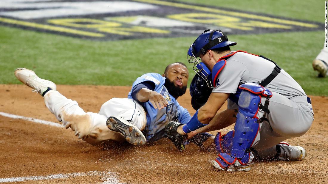 Dodgers catcher Austin Barnes tags out Rays left fielder Manuel Margot trying to steal home during the fourth inning. 