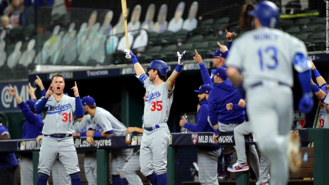 Joc Pederson and Cody Bellinger of the Los Angeles Dodgers react to a Max Muncy solo home run in the fifth inning during Game 5 of the World Series at Globe Life Field on Sunday, October 25, in Arlington, Texas.