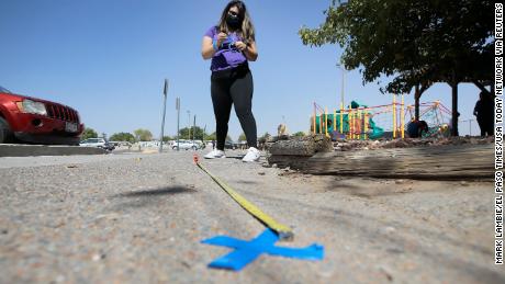 Audrey Rodriguez of the Bowling Family YMCA in Northeast El Paso prepares the venue for early voting by putting out social distancing and direction markers from the entrance into the parking lot.