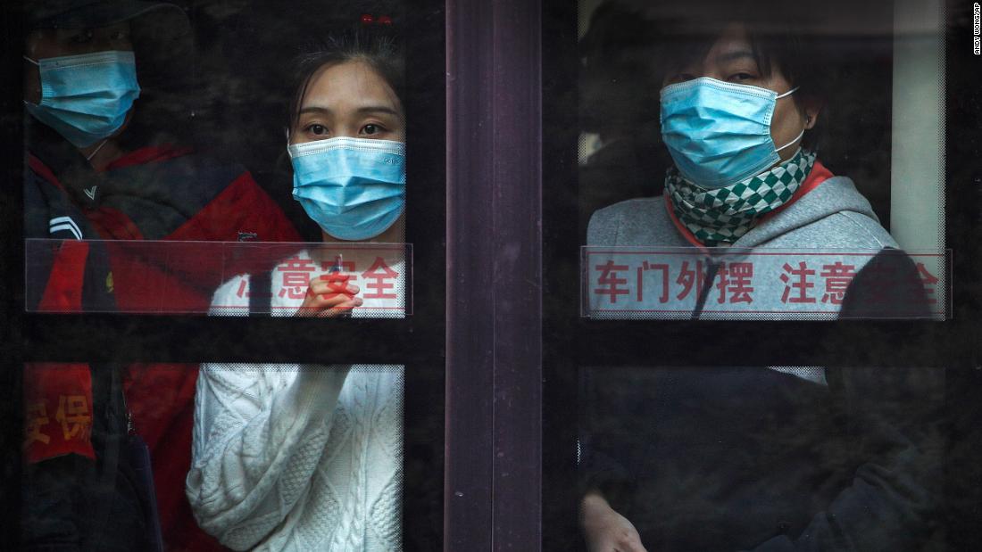 Commuters ride a bus in Beijing during rush hour on October 26.