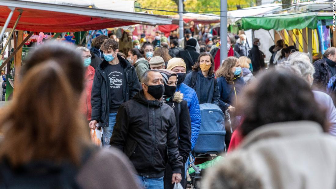 People shop at an outside market in Berlin on October 27.