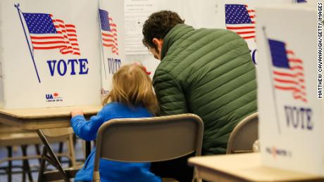 Nick Botto votes with his daughter Violet, age 3, in the state primary on February 11 in Bedford, New Hampshire.