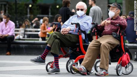 People wear protective face masks in Washington Square Park in New York City during the coronavirus pandemic.