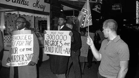 Voting rights protesters -- and a man holding a Confederate flag -- demonstrate in Indianapolis, Indiana, in April 1964.