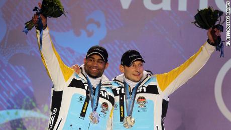 Adjei (left) and Thomas Florschütz receive silver medals in the men&#39;s two-man bobsled at the 2010 Winter Olympics. 