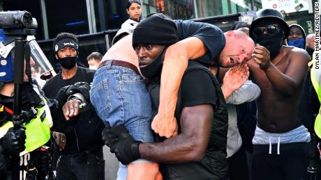 This image of Patrick Hutchinson carrying an injured White man at a Black Lives Matter protest went viral in June.