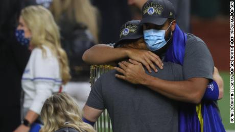 Justin Turner hugs teammate Kenley Jansen after testing positive for the coronavirus.