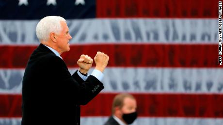 US Vice President Mike Pence walks on stage at a &quot;Make America Great Again!&quot; campaign event at Oakland County International Airport in Waterford, Michigan, on October 22, 2020. 