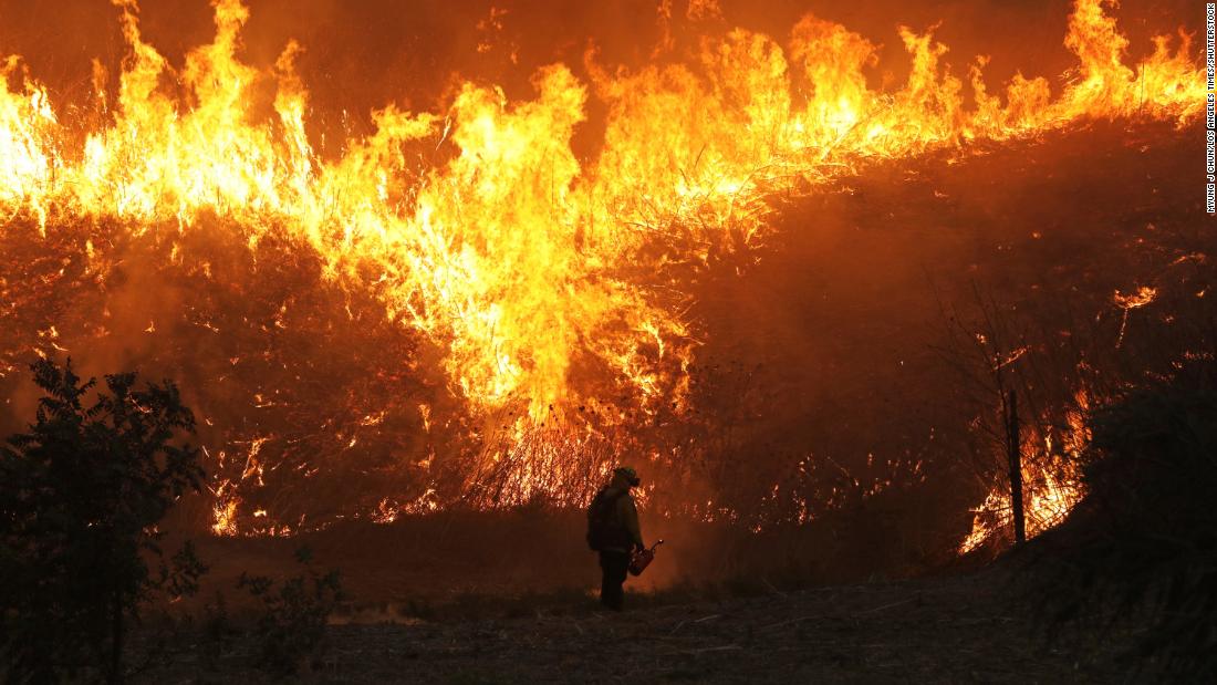 Firefighters conduct a backfire operation in Chino Hills on October 27, 2020.