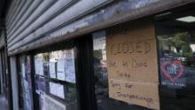 A storefront displays a closed sign as it remains shuttered due to a COVID-19 area infection rate increase, Thursday, Oct. 15, 2020, in the Far Rockaway neighborhood of the borough of Queens in New York. After shutdowns swept entire nations during the first surge of the coronavirus earlier this year, some countries and U.S. states are trying more targeted measures as cases rise again around the world. New York&#39;s new round of shutdowns zeroes in on individual neighborhoods, closing schools and businesses in hot spots measuring just a few square miles.  (AP Photo/John Minchillo)