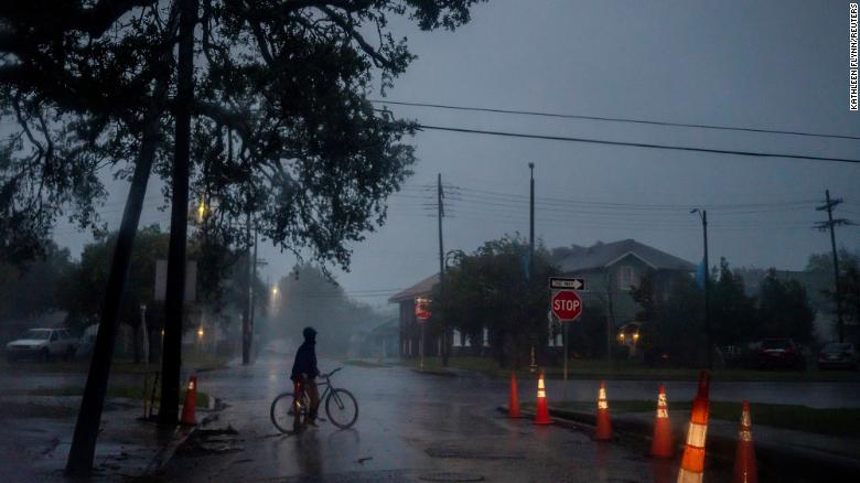 A man walks through heavy wind and rain caused by Zeta in New Orleans Thursday.