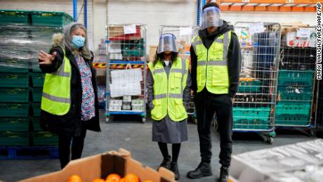 Rashford, right, and his mother Melanie, center, visit FareShare Greater Manchester at New Smithfield Market, Manchester, England, Thursday Oct. 22, 2020. 