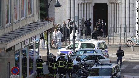 French elite police enter the Basilica of Notre-Dame de Nice as forensics officers wait outside after a knife attack on October 29.