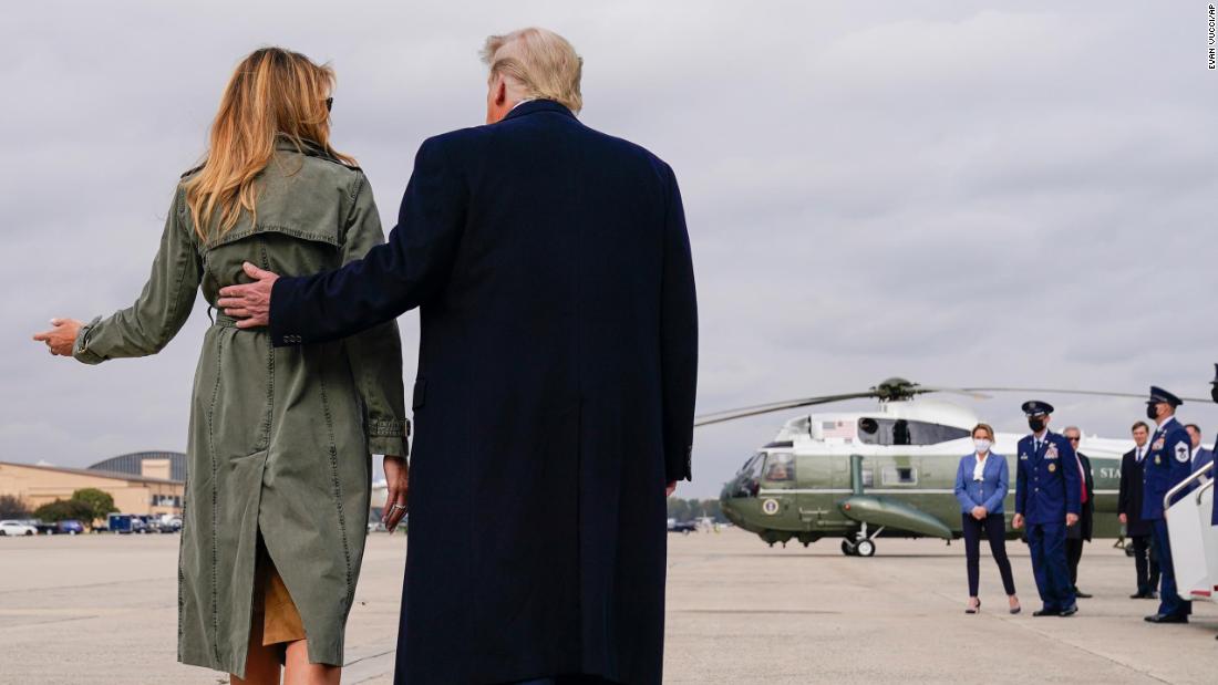 Trump walks with first lady Melania Trump after a day of campaign rallies in Michigan, Wisconsin and Nebraska in October 2020.