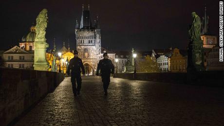 On October 28, the Czech government imposed a curfew, and the police walked across the empty Charles Bridge in Prague.