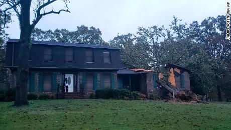 A fallen tree is seen on a home damaged by Zeta Thursday in Lincoln, Alabama.