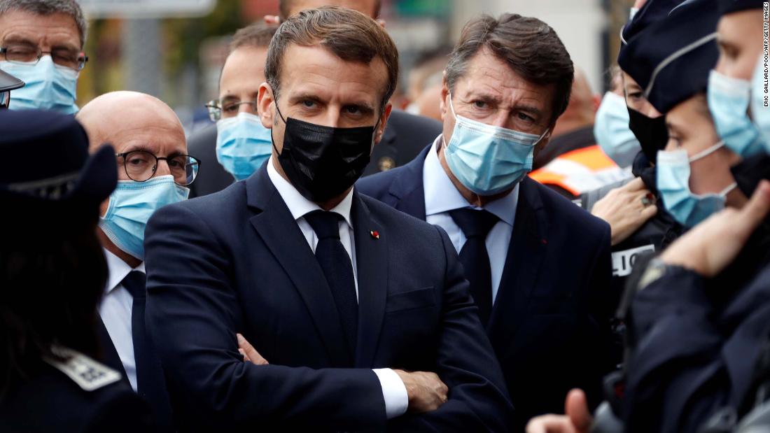 French President Emmanuel Macron, center left, and Nice Mayor Christian Estrosi, center right, visit the scene.