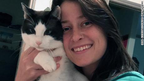 Kaitlyn Romoser and her 7-year-old cat, Phoenix, both tested positive for the coronavirus. Romoser tested positive in March and again in September.