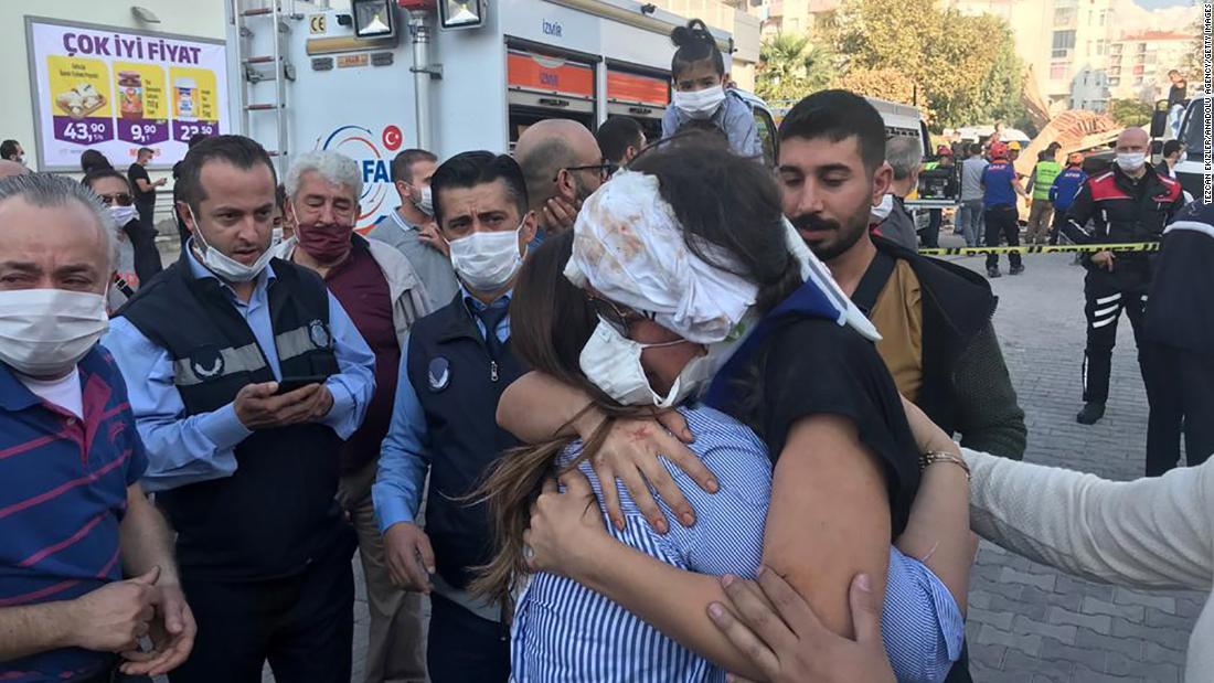 A wounded woman hugs a relative after being rescued from a building in Izmir.