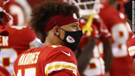 Patrick Mahomes of the Kansas City Chiefs dons a mask on the sideline earlier this season.