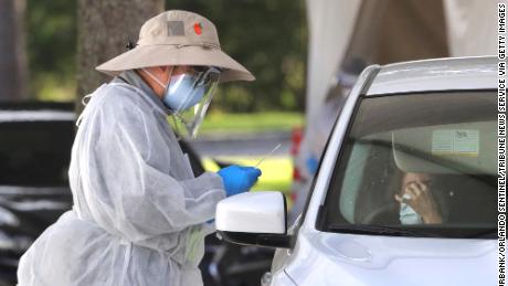 A medical professional prepares to apply a nasal swab during testing at the Orange County Health Services Covid-19 drive-thru site at Barnett Park in Orlando, Fla., Thursday, October 29, 2020. The free tests are available 8am to 1pm daily at the park adjacent to the Central Florida Fairgrounds on West Colonial Drive. (Joe Burbank/Orlando Sentinel/Tribune News Service via Getty Images)