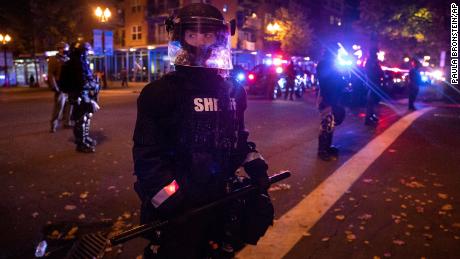 Vancouver police stand guard as a tense standoff took place after Friday's vigil.