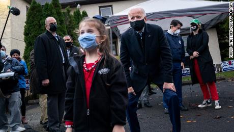 Biden poses for a picture with a young girl during a canvassing kick-off event on November 01, 2020 in Philadelphia, Pennsylvania.