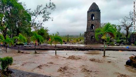 Floodwaters pass by Cagsawa ruins, a famous tourist spot in Daraga, Albay province, central Philippines as Typhoon Goni hit the area Sunday, November 1.
