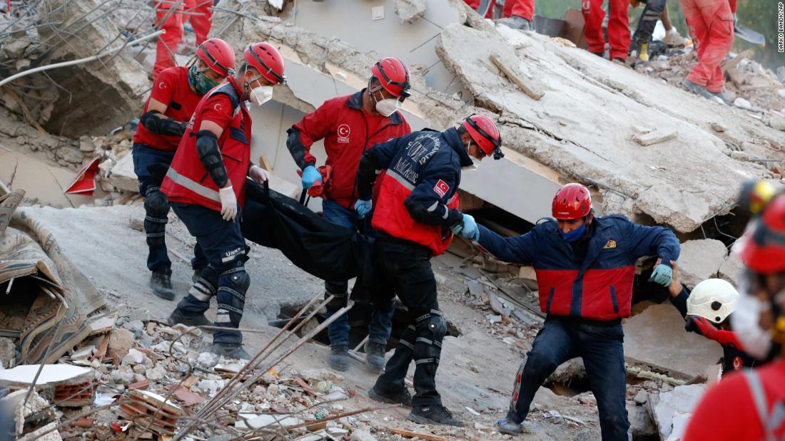 Members of a rescue crew carry a victim&#39;s body in Izmir.